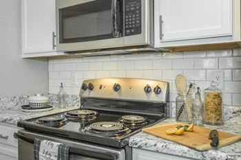 a kitchen with a stove and a microwave